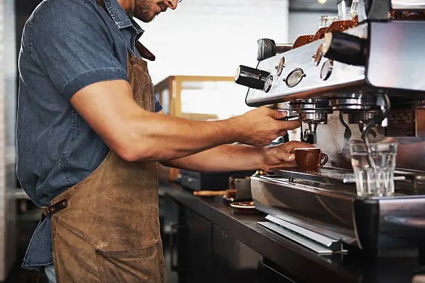 Barista pulling espresso at Brew